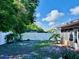 This backyard is surrounded by a white fence and includes trees and landscaping at 435 Andes Ave, Orlando, FL 32807