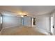 Spacious carpeted bedroom with ceiling fan, neutral paint, and access to an ensuite bathroom at 435 Andes Ave, Orlando, FL 32807