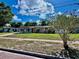Charming single-story home with a well-manicured lawn and mature trees in a sunny setting at 435 Andes Ave, Orlando, FL 32807