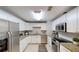 Well-lit kitchen featuring white cabinets, stainless steel appliances, and granite countertops at 435 Andes Ave, Orlando, FL 32807