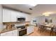 Modern kitchen boasts granite countertops, white cabinetry, and an adjacent dining area at 435 Andes Ave, Orlando, FL 32807