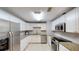 Bright kitchen with white cabinets, stainless steel appliances, and granite countertops at 435 Andes Ave, Orlando, FL 32807