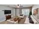 Bright living room with a ceiling fan, large window, and a comfortable seating arrangement at 435 Andes Ave, Orlando, FL 32807