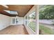 Covered patio features beautiful tile floor, wood ceiling, and view of the spacious backyard with a shed at 435 Andes Ave, Orlando, FL 32807