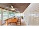 Inviting sunroom with a ceiling fan, wood ceiling, and a dining and seating area at 435 Andes Ave, Orlando, FL 32807