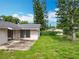 View of the home's back yard with a patio and lush lawn at 4611 Cranston Pl, Orlando, FL 32812