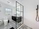Modern bathroom featuring black and white tile, a dual sink vanity, and a glass-enclosed shower at 4611 Cranston Pl, Orlando, FL 32812