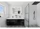 Modern bathroom featuring a double vanity, backlit mirror, and glass-enclosed shower with a rainfall showerhead at 4611 Cranston Pl, Orlando, FL 32812
