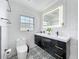 Modern bathroom featuring black and white tile, a dual sink vanity, and a glass-enclosed shower at 4611 Cranston Pl, Orlando, FL 32812