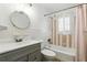 Traditional bathroom with a round mirror, and a shower-tub combo with vintage tile and fixtures at 4611 Cranston Pl, Orlando, FL 32812