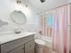 Charming bathroom with stylish vanity, round mirror and classic white tile at 4611 Cranston Pl, Orlando, FL 32812