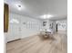 Bright dining area with wood floors, white walls, white table with seating, and views into the kitchen, creating a modern feel at 4611 Cranston Pl, Orlando, FL 32812