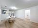 Inviting dining space with white marble table, chairs, and wood flooring, complemented by stylish wall décor at 4611 Cranston Pl, Orlando, FL 32812
