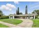 Inviting single-story home featuring a circular driveway, fresh exterior paint, and charming shutters at 4611 Cranston Pl, Orlando, FL 32812