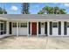 Close up of home's front door with white pillars and black shutters at 4611 Cranston Pl, Orlando, FL 32812