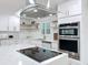 Close up of modern kitchen with stainless steel appliances, stylish range hood and custom backsplash at 4611 Cranston Pl, Orlando, FL 32812