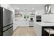 Bright kitchen featuring a center island, white cabinets, and stainless steel appliances at 4611 Cranston Pl, Orlando, FL 32812