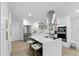 Bright kitchen with a center island, white cabinets, and stainless steel appliances at 4611 Cranston Pl, Orlando, FL 32812