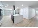 Bright kitchen features stainless appliances, a modern range hood, and a spacious island with seating at 4611 Cranston Pl, Orlando, FL 32812