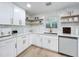Kitchen with white cabinets, stainless steel appliances, and a mosaic tile backsplash at 4611 Cranston Pl, Orlando, FL 32812