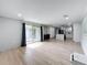 Open-concept living room area featuring wood floors, recessed lighting, and sliding glass doors to the outside at 4611 Cranston Pl, Orlando, FL 32812