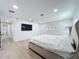 Bright main bedroom featuring a large bed, wood floors, plantation shutters, and access to the hallway at 4611 Cranston Pl, Orlando, FL 32812