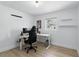 Bright home office with a modern desk, ergonomic chair, and minimalist decor on wood floors at 4611 Cranston Pl, Orlando, FL 32812