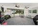 Enclosed sunroom with two ceiling fans and screened windows overlooking the backyard at 4611 Cranston Pl, Orlando, FL 32812