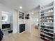Bright walk-in closet with custom shelving, storage, and adjacent bathroom and bedroom at 4611 Cranston Pl, Orlando, FL 32812