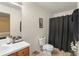 Cozy bathroom featuring a white toilet, shower, and vanity with counter space at 470 Cardinal Ct, Kissimmee, FL 34759