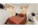 Cozy bedroom with a queen-sized bed, a wheelchair, dresser, and soft lighting at 470 Cardinal Ct, Kissimmee, FL 34759