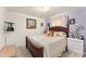 Bedroom featuring a spacious bed and white nightstand for storage, lit by an overhead light at 470 Cardinal Ct, Kissimmee, FL 34759