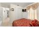 Cozy bedroom featuring closet, dresser and a TV, plus lovely curtains and view to hall at 470 Cardinal Ct, Kissimmee, FL 34759