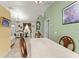 Charming dining area with tile floors, decorative table, and views into a furnished living room at 470 Cardinal Ct, Kissimmee, FL 34759