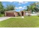 Charming single-story home with well-manicured lawn, driveway, and attached garage at 470 Cardinal Ct, Kissimmee, FL 34759