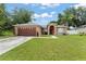 Charming single-story home featuring a well-maintained lawn and a two-car garage at 470 Cardinal Ct, Kissimmee, FL 34759