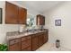 Well-lit kitchen featuring ample cabinet space and a double basin stainless steel sink at 470 Cardinal Ct, Kissimmee, FL 34759