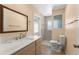 Bright bathroom featuring a new vanity top, decorative mirror, and tile shower with updated fixtures at 473 Burnt Tree Ln, Apopka, FL 32712
