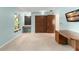Spacious bedroom featuring carpeted floors, dual windows, and a closet with wooden paneled doors at 473 Burnt Tree Ln, Apopka, FL 32712