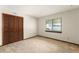 Cozy bedroom featuring carpeted floors, a window with wood trim, and a closet with paneled doors at 473 Burnt Tree Ln, Apopka, FL 32712