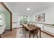 Stylish dining room with a large window, contemporary decor, and a connected living space at 473 Burnt Tree Ln, Apopka, FL 32712