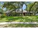 Charming home with well-manicured front yard, mature trees, and brick facade at 473 Burnt Tree Ln, Apopka, FL 32712