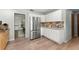 Modern kitchen features stainless steel appliances, ample counter space, and sleek white cabinetry at 473 Burnt Tree Ln, Apopka, FL 32712
