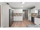 Modern kitchen with stainless steel appliances and sleek white cabinets provides ample storage and functionality at 473 Burnt Tree Ln, Apopka, FL 32712