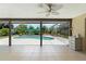 Covered patio with tile flooring, ceiling fan and view of the beautiful in-ground pool and backyard at 473 Burnt Tree Ln, Apopka, FL 32712