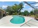 In-ground pool in backyard with lush landscaping and pergola with outdoor seating area at 473 Burnt Tree Ln, Apopka, FL 32712