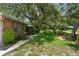 Beautifully landscaped yard with mature trees adding shade and curb appeal to the property at 473 Burnt Tree Ln, Apopka, FL 32712