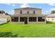 The backyard has a large green lawn and screened-in patio at 512 Bella Rosa Cir, Sanford, FL 32771