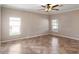 Bright bedroom with tiled floor, ceiling fan, base molding and two windows at 512 Bella Rosa Cir, Sanford, FL 32771
