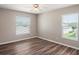 Bedroom with two windows and wood-look flooring at 512 Bella Rosa Cir, Sanford, FL 32771